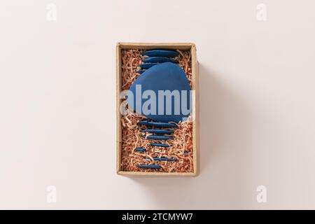 Old blue chalk of tailor in paper box on white background Stock Photo