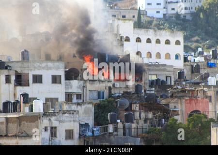 Jenin, Palestine. 13th Dec, 2023. Smoke rises from a Palestinian house in the Jenin refugee camp after it was targeted by the Israeli army. During a military operation inside Jenin camp searching for militants. Violence has escalated in the Palestinian territories since the war against Hamas in the Gaza Strip. Credit: SOPA Images Limited/Alamy Live News Stock Photo