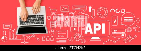 Female hands with laptop and virtual screen with abbreviation API on red background Stock Photo
