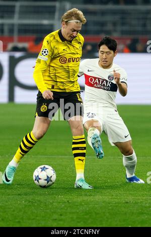 Dortmund, Germany. 13th Dec, 2023. Julian Brandt (L) of Borussia Dortmund vies with Lee Kang-in of Paris Saint-Germain during the UEFA Champions League Group F match between Borussia Dortmund and Paris Saint-Germain (PSG) in Dortmund, Germany, on Dec. 13, 2023. Credit: Joachim Bywaletz/Xinhua/Alamy Live News Stock Photo