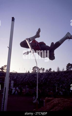 PALO ALTO, CA - JULY 1:  General view of a silhouetted high jumper using the straddle technique as he knocks off the bar with his jump during the 1960 U.S. Olympic Track and Field Trials on July 1, 1960 at Stanford Stadium in Palo Alto, California.  (Photo by Hy Peskin) Stock Photo