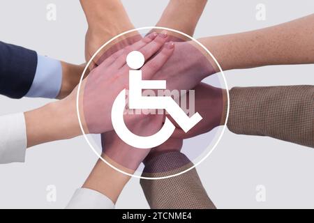 Inclusive workplace culture. International symbol of access. People holding hands together, closeup Stock Photo