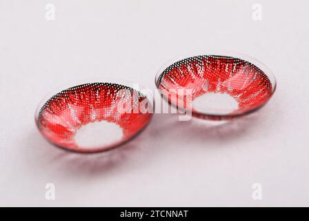 Two red contact lenses on white background Stock Photo