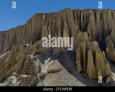 Hoodoo formations contain caves carved by humans 3000 years ago near Yara village - upper Mustang District, Nepal Stock Photo