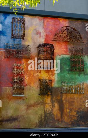 Colorful wall with wrought iron pattern at an alley in Santana Row,  San Jose, California, USA Stock Photo