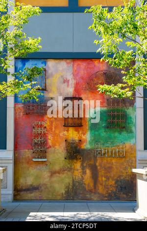 Colorful wall with wrought iron pattern at an alley in Santana Row,  San Jose, California, USA Stock Photo