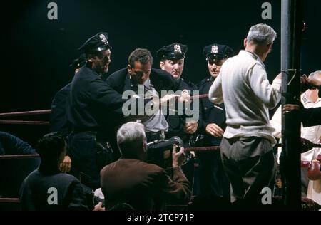 NEW YORK, NY - SEPTEMBER 23:  Police and trainers exit the ring before the match between Carmen Basilio and Sugar Ray Robinson for the 1957 World Middleweight Title on September 23, 1957 at Yankee Stadium in the Bronx, New York.  (Photo by Hy Peskin) Stock Photo