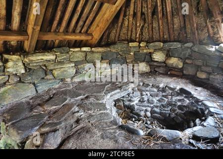 Inside the kiln at the historic Viking kiln and mill on Lewis Island, Scotland. A fire in the pit heats the tunnel under the floor to dry the corn Stock Photo