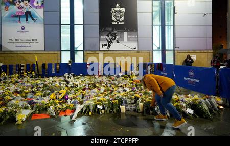 File photo dated 4-11-2023 of fans looking at floral tributes outside the Motorpoint Arena, Nottingham. Ice hockey and the wider sporting world was shocked by the death of Nottingham Panthers player Adam Johnson in what the club described as a freak accident. The 29-year-old American reportedly suffered a slashed neck during the second period of a Challenge Cup tie with the Sheffield Steelers at at Sheffield’s Utilita Arena. Issue date: Thursday December 14, 2023. Stock Photo