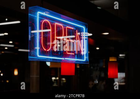 A colorful neon sign declaring the restaurant open. Stock Photo
