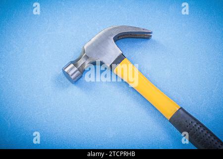 Claw hammer on blue background Building concept Stock Photo
