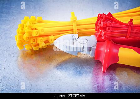Cutting pliers for tying cables on a scratched metallic background Stock Photo