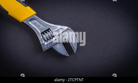 Adjustable spanner with yellow handle Stock Photo