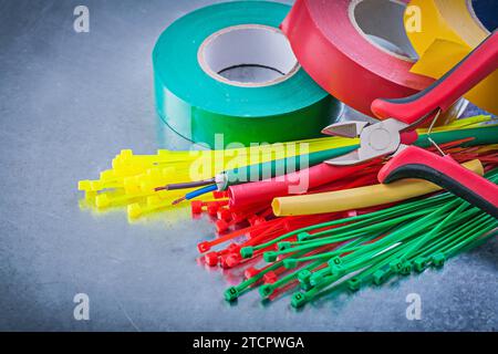 Insulating tapes Plastic cable ties Electrical wires Cutting pliers Stock Photo