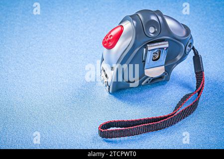 Tape measure on blue background Construction concept Stock Photo