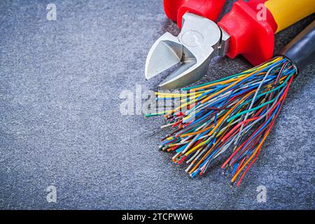 Multicoloured electric cables nippers on black background electricity concept Stock Photo