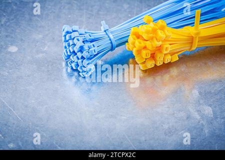 Self-locking plastic binding cables on a metallic base Construction concept Stock Photo