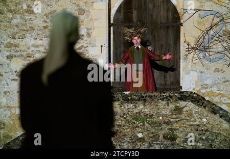 Actors from the London Touring Players performing the parts of Ebenezer Scrooge and the Ghost of Christmas Present take part in a dress rehearsal for a production of Charles Dickens' A Christmas Carol in the ruins of Beaulieu Abbey in Beaulieu, Hampshire. Picture date: Wednesday December 13, 2023. Stock Photo