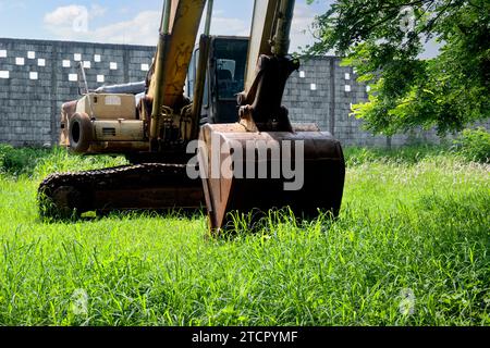 Old broken rusty excavator on the field Stock Photo