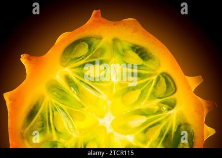 Kiwano or Horned Melon (Cucumis metuliferus) sliced in a half on black background isolated Stock Photo
