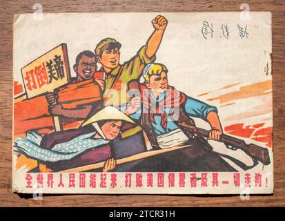 A propaganda poster during the Chinese Cultural Revolution. The Red Guard and the people of Asia, Africa and Latin America hold aloft slogans against Stock Photo