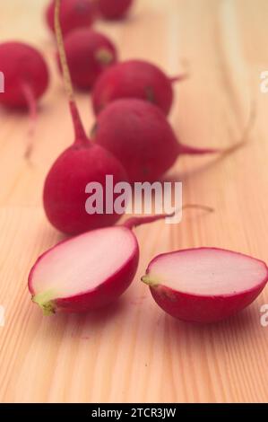 Fresh red raw raddish over pine wood table closeup Stock Photo