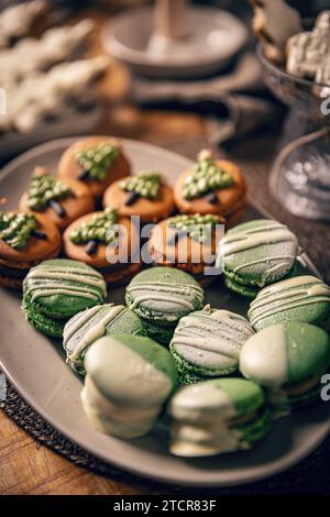 Beautifully decorated Christmas macarons on festive table Stock Photo