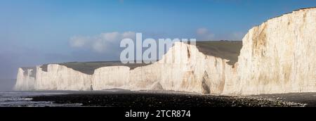 Panoramic view of the chalk cliffs of the seven sisters on the south downs from Birling Gap beach on the east Sussex coast south east England UK Stock Photo