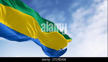 National flag of Gabon waving in the wind on a clear day. Three equal horizontal bands of green, yellow, and blue. 3d illustration render. Fluttering Stock Photo