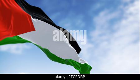Palestine national flag waving on a clear day. Three black, white, green stripes with red triangle on left. 3d illustration render. Selective focus. C Stock Photo
