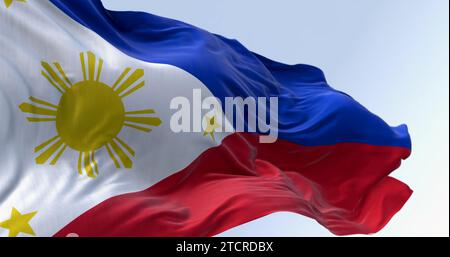 Close-up of Philippines national flag waving. Two equal horizontal blue and red bands, white triangle on the left, golden-yellow sun with eight beams Stock Photo
