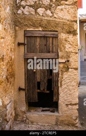 An old wooden door in an abandoned house in Stari Grad historic centre of the coastal town of Novi Vinodolski, Primorje-Gorski Kotar County, Croatia Stock Photo