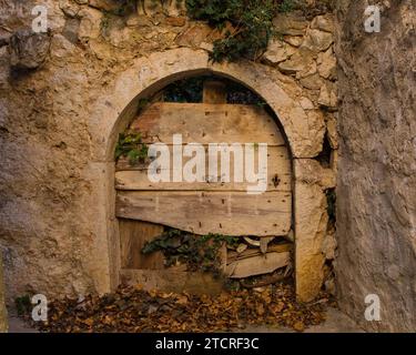 An old wooden door in an abandoned house in Stari Grad historic centre of the coastal town of Novi Vinodolski, Primorje-Gorski Kotar County, Croatia Stock Photo