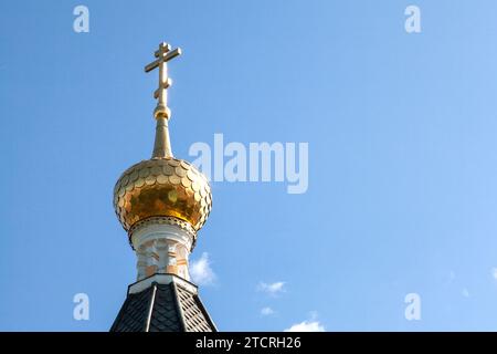 The dome of an Orthodox church covered with golden tiles against the sky. Stock Photo