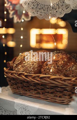 Fresh multigrain bread in a wicker basket in a baked goods store Stock Photo