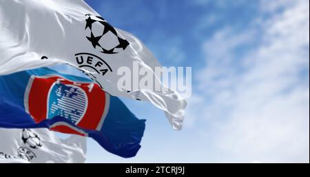 London, UK, Dec 1 2023: UEFA and UEFA Champions league flags waving together. European football competition. Rippled fabric. Illustrative editorial 3d Stock Photo