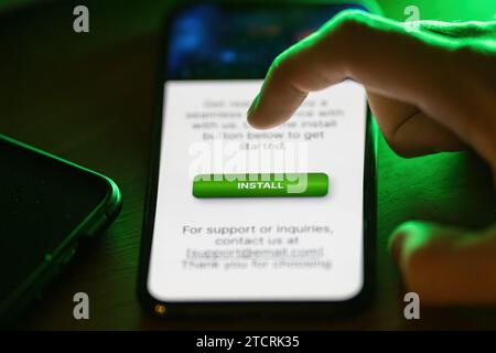 Clicking on green install button on smartphone Stock Photo