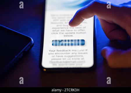 Clicking on update button on smartphone app Stock Photo