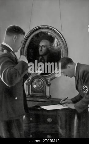 In the Reich Chancellery, Adolf Hitler is seen with his Chief of Staff, Viktor Lutze. This setting, central to the political operations of Nazi Germany, underscores the significant working relationship between Hitler and his senior staff. Lutze, as a key figure in the regime, played a vital role in coordinating activities and executing policies. Stock Photo