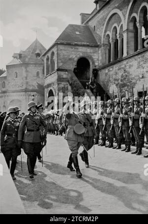 In 1934, Adolf Hitler is pictured in front of the Goslar Imperial Palace during the Harvest Thanksgiving Festival. This setting, rich in historical significance, provides a backdrop for a festival that was used by the Nazi regime to promote its agrarian and folkish ideologies. The Harvest Thanksgiving Festival, under the Nazi regime, became an event not only for celebrating the harvest but also for disseminating propaganda and reinforcing the connection between the regime and traditional Germanic culture. Stock Photo