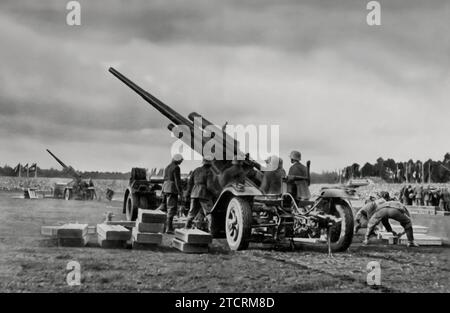Captured during the Tag der Wehrmacht (Day of the Armed Forces) in 1935 in Nuremberg, this image shows Flugabwehrgeschütze (anti-aircraft guns) in position. It highlights the military might and preparedness that the Nazi regime showcased, emphasizing their focus on air defense capabilities as a significant aspect of their military demonstrations and propaganda. Stock Photo