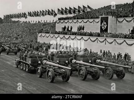 At the 1935 Nuremberg Rally, on the Day of the Armed Forces, this image showcases the motorized heavy artillery of the Wehrmacht. The display of such powerful and modernized artillery units reflects the significant advancements in military technology and strategy under the Nazi regime. This event was a key opportunity to demonstrate Germany's renewed military strength and capabilities, emphasizing the regime's focus on a well-equipped and mobile armed force. Stock Photo