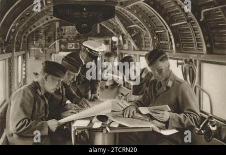 In this image, German recruits in the Luftwaffe, the German Air Force, are depicted seated inside an aircraft, engaged in a navigation training session. This part of their military training was crucial, as navigation skills are fundamental for any pilot, especially in the context of World War II aerial warfare. The recruits are seen learning to read and interpret various navigation instruments and maps, skills essential for successful mission planning and execution. Stock Photo