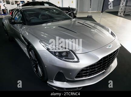 Three-quarters Front View of a 2024, Silver  Aston Martin DB12 Coupe, on display at the 2023 British Motor Show Stock Photo