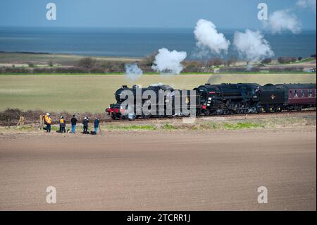 enthusiasts form a line to photograph doubled up steam trains at weybourne north norfolk, BR Standard Class 9F 2-10-0, 6271,Black Prince .Morayshire ( Stock Photo