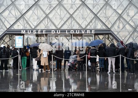Visitors queuing to enter the Louvre Museum on December 12, 2023 in Paris, France. Visiting the Louvre will soon cost more than ever, as the world's biggest museum seeks to cover rising costs without lifting caps on crowds. Ticket prices are set to climb from € 17 to € 22 next month, an increase of nearly 30 percent. The hike, which comes into effect from 15 January, is the first time the museum has raised its prices since 2017. It comes around six months before the 2024 Paris Olympics, which are expected to flood the French capital with tourists from around the world. Photo by Alexis Jumeau/A Stock Photo