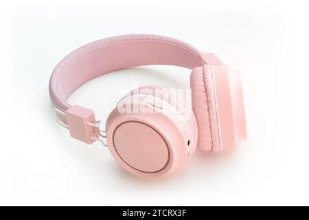 Wireless modern pink Bluetooth headphones on white background Stock Photo