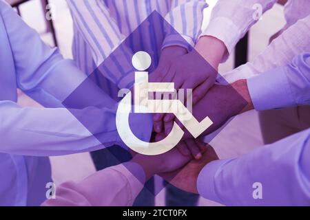 Inclusive workplace culture. International symbol of access. People holding hands together, closeup Stock Photo