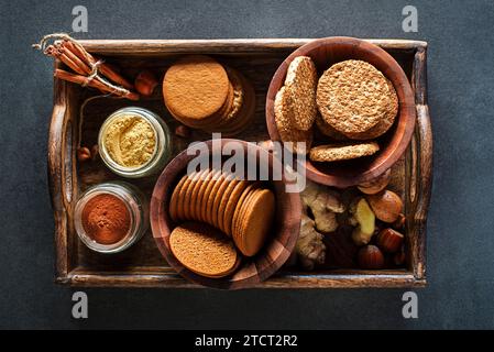 Delicious healthy homemade cereal oatmeal and gingerbread cookies served on tray background Stock Photo