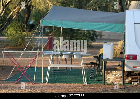 Letaba Rest Camp, Kruger National Park, South Africa - April 14, 2012 :  caravan and tent, table and chair in shade  under trees in camping site, Stock Photo